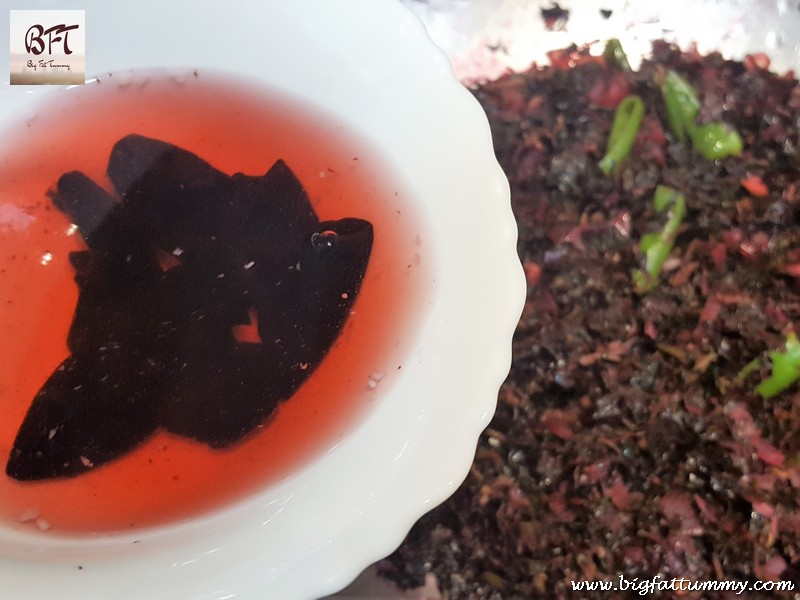 Preparation of Tamde Patol Bhaji (red amaranth in coconut milk)